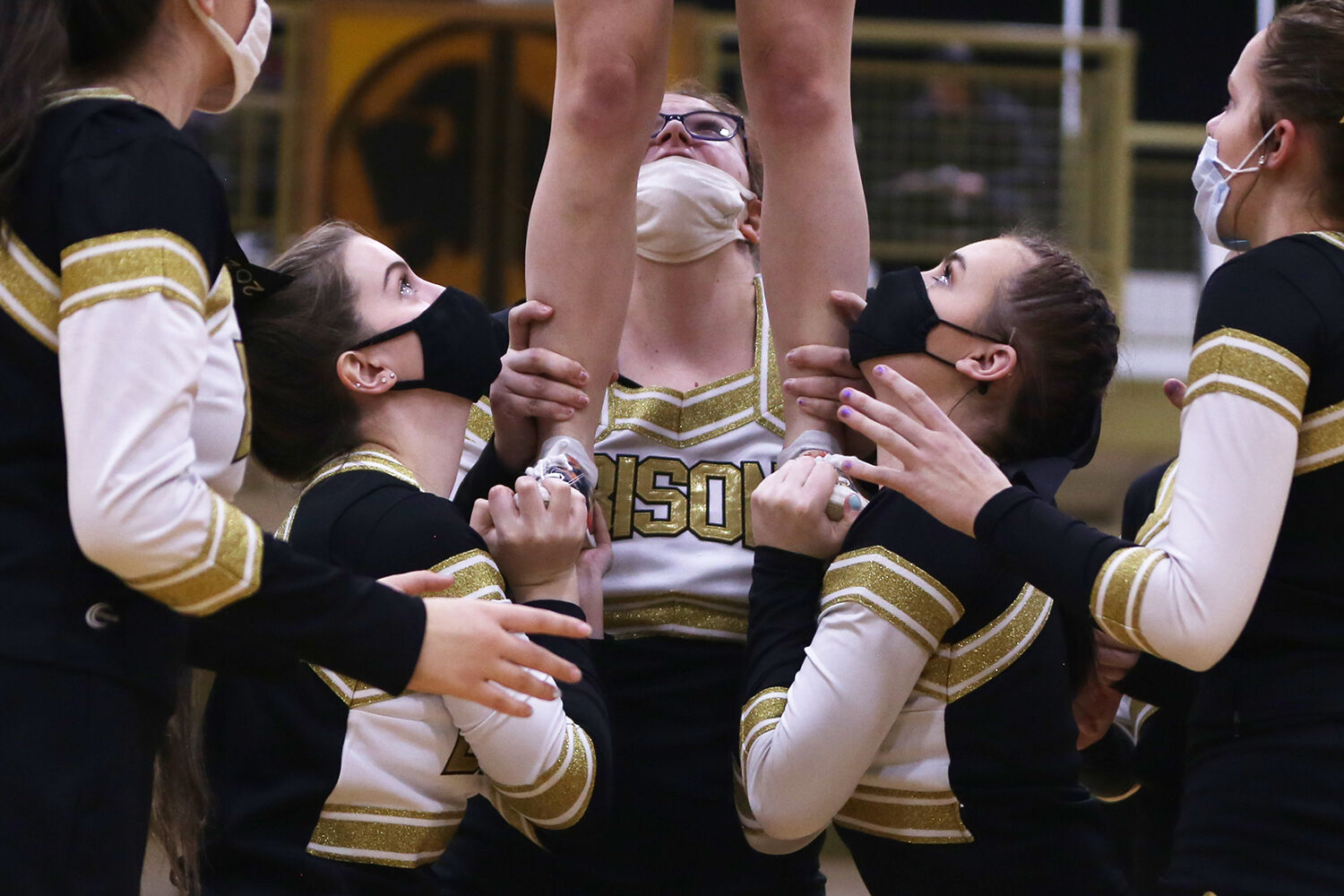 Madison Bartlett, Cadance Foust and Danielle Zimmerschied hold a teammate
